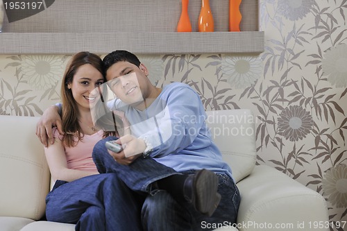 Image of couple relax at home on sofa in living room