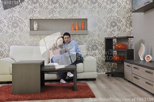 Image of couple relax at home on sofa in living room
