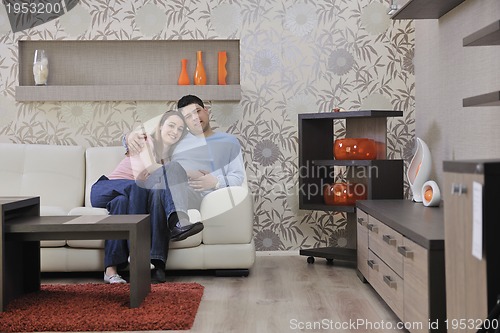 Image of couple relax at home on sofa in living room