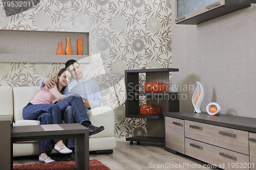 Image of couple relax at home on sofa in living room