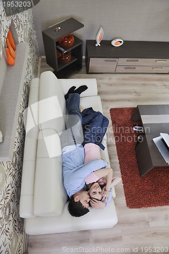 Image of couple relax at home on sofa in living room