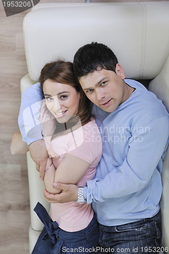 Image of couple relax at home on sofa in living room