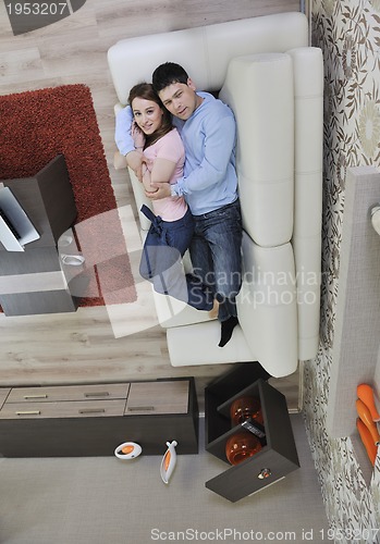 Image of couple relax at home on sofa in living room