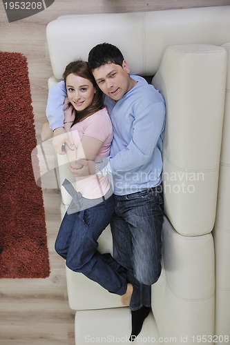 Image of couple relax at home on sofa in living room