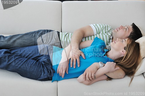 Image of couple relax at home on sofa in living room