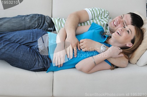 Image of couple relax at home on sofa in living room