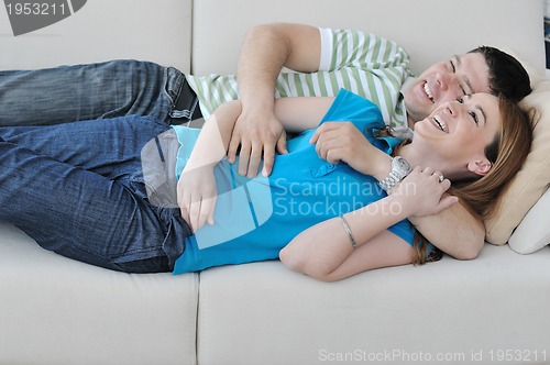 Image of couple relax at home on sofa in living room