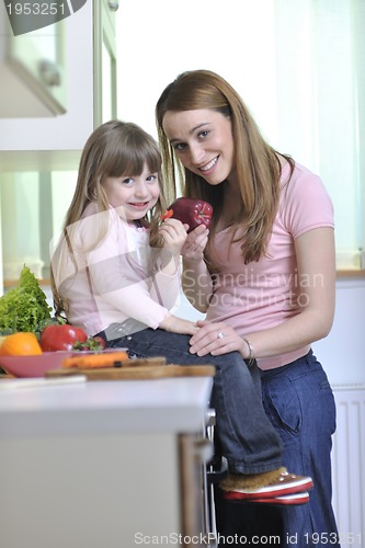 Image of happy daughter and mom in kitchen
