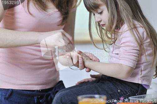 Image of happy daughter and mom in kitchen