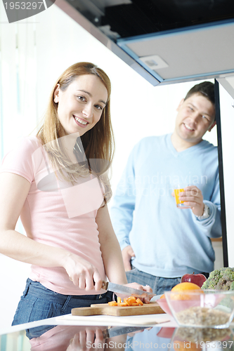 Image of couple have fun and preparing healthy food in kitchen