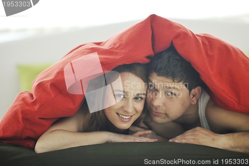 Image of young couple in bed