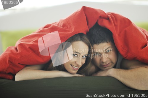 Image of young couple in bed