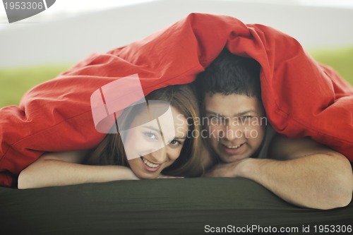 Image of young couple in bed