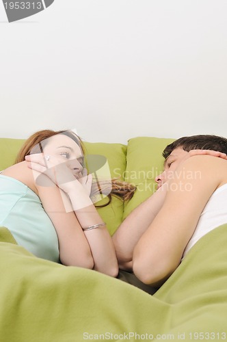 Image of young couple in bed