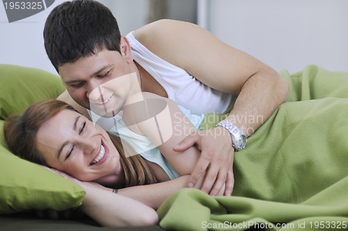 Image of young couple in bed