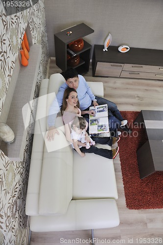 Image of happy family looking photos at home