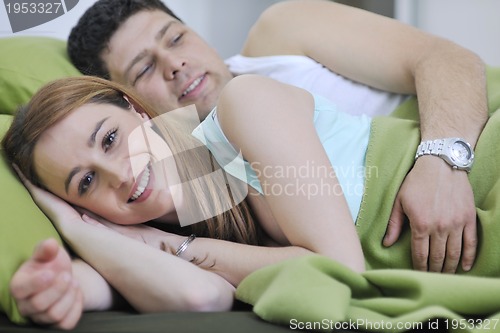 Image of young couple in bed