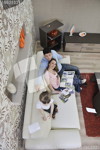 Image of happy family looking photos at home