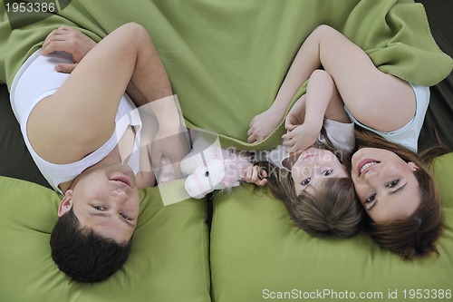 Image of happy young family eat breakfast in bed