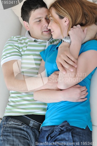 Image of couple relax at home on sofa in living room