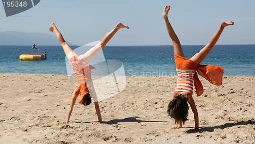 Image of Two girls doing cartwheel