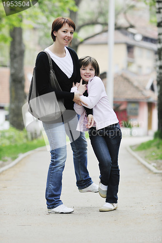 Image of happy girl and mom outdoor