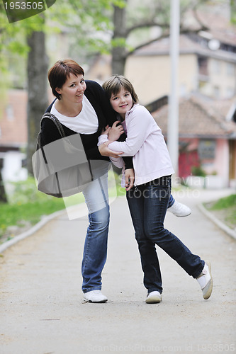 Image of happy girl and mom outdoor