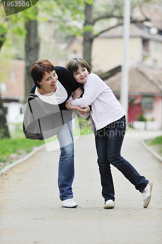 Image of happy girl and mom outdoor