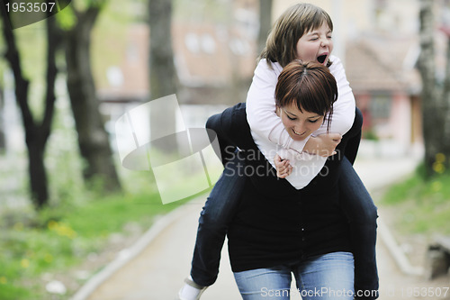 Image of happy girl and mom outdoor