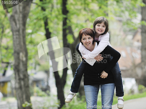 Image of happy girl and mom outdoor