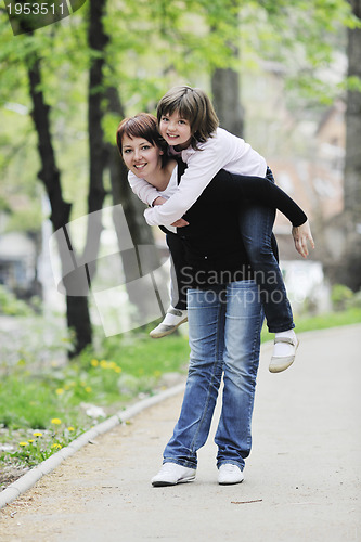 Image of happy girl and mom outdoor