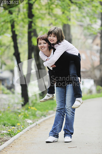 Image of happy girl and mom outdoor