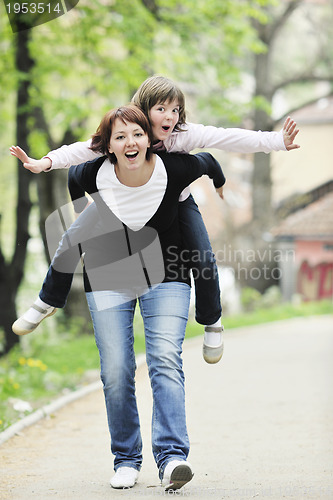 Image of happy girl and mom outdoor
