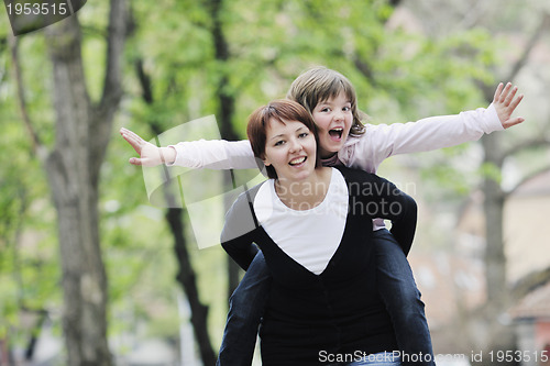 Image of happy girl and mom outdoor