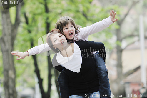 Image of happy girl and mom outdoor