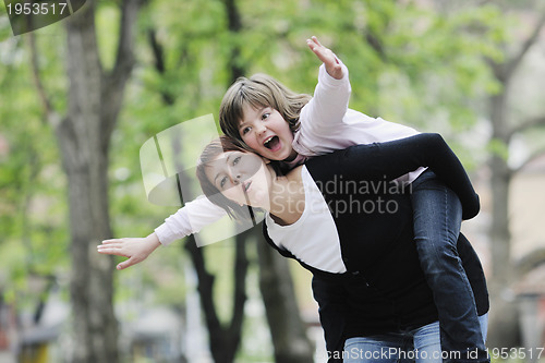 Image of happy girl and mom outdoor