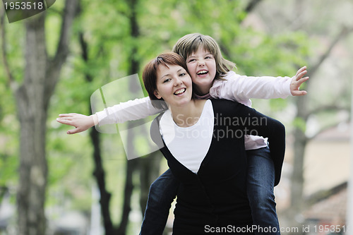 Image of happy girl and mom outdoor