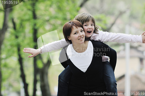 Image of happy girl and mom outdoor