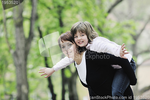 Image of happy girl and mom outdoor