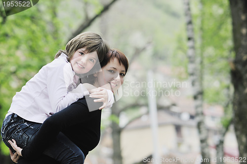 Image of happy girl and mom outdoor