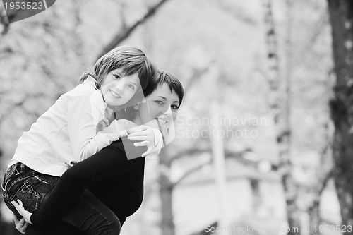 Image of happy girl and mom outdoor