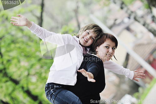 Image of happy girl and mom outdoor