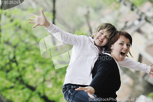 Image of happy girl and mom outdoor