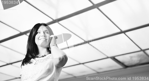 Image of young happy business woman talking by cellphone