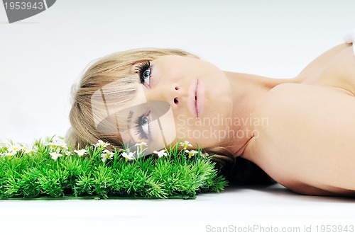 Image of woman face on grass 