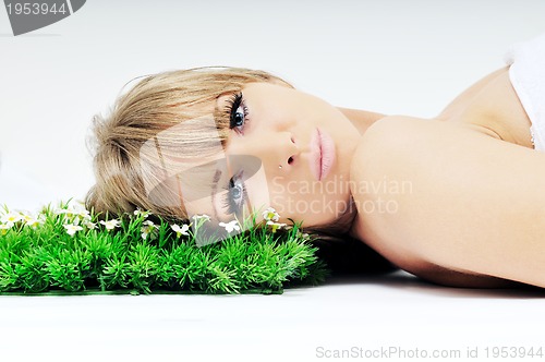 Image of woman face on grass 