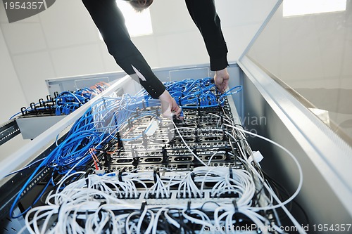 Image of young it engeneer in datacenter server room