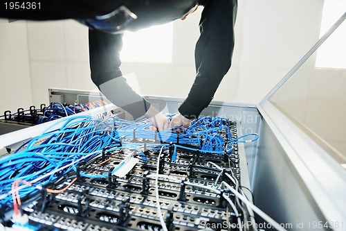 Image of young it engeneer in datacenter server room