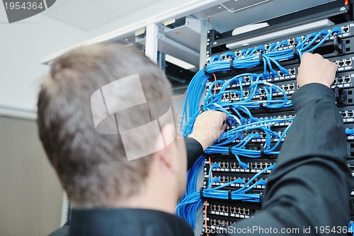 Image of young it engeneer in datacenter server room