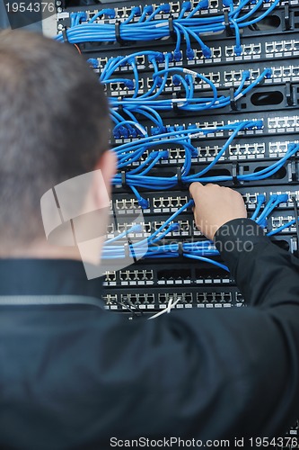 Image of young it engeneer in datacenter server room